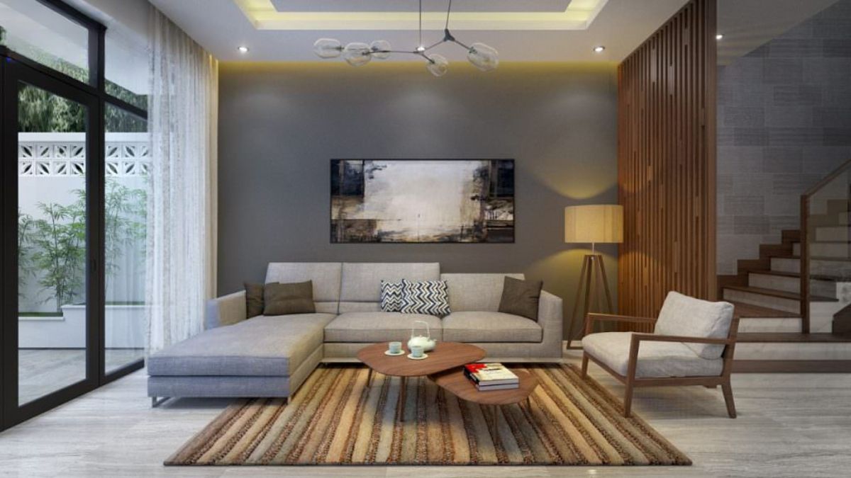 Ph&ograve;ng kh&aacute;ch nh&agrave; ống 6m2 được trang tr&iacute; đ&egrave;n trần nghệ thuật, tranh treo tường v&agrave; thảm trải s&agrave;n bắt mắt