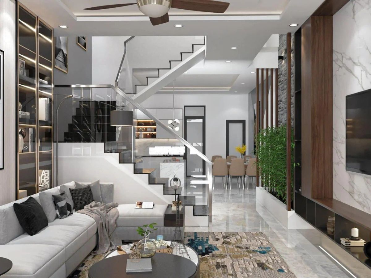 Cầu thang được đặt nằm giữa khu vực ph&ograve;ng kh&aacute;ch v&agrave; ph&ograve;ng bếp của nh&agrave; ống